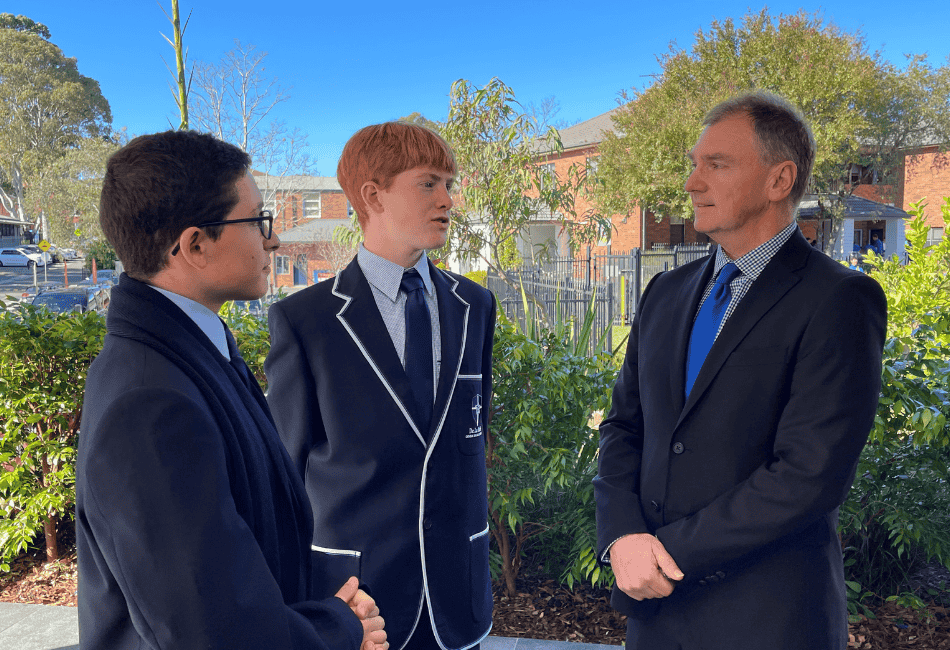 An image of Principal Peter Buxton speaking with two male students at De La Salle Catholic College Caringbah